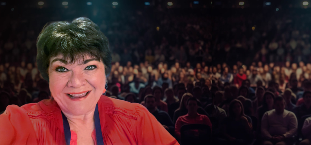 Marcy Heim standing in front of an audience